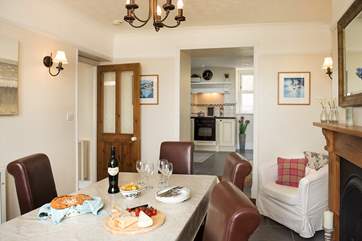 The open archway leading into the kitchen makes it feel a very sociable space. Two steps lead up to the kitchen.