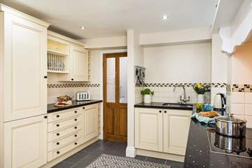 Leading off the kitchen is a utility-area and the shower-room.