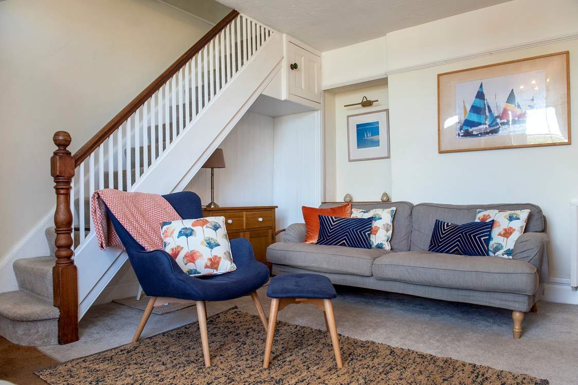 The stairs to the first floor lead up from the sitting-room.