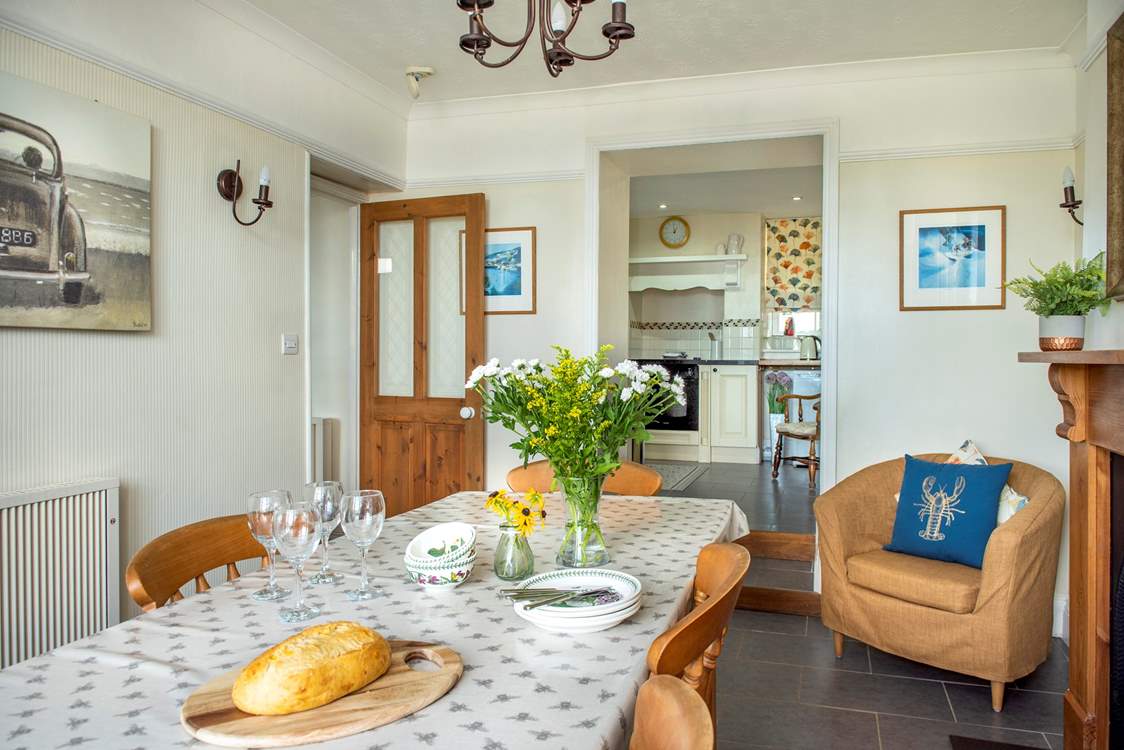 The open archway leading into the kitchen makes  it feel a very sociable space. Two steps lead up to the kitchen.