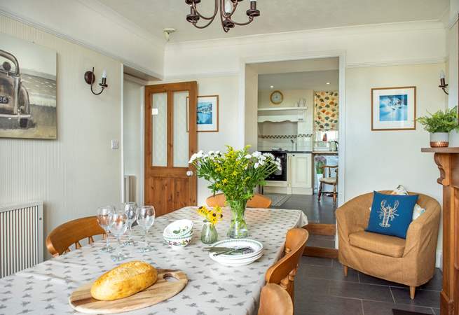 The open archway leading into the kitchen makes  it feel a very sociable space. Two steps lead up to the kitchen.