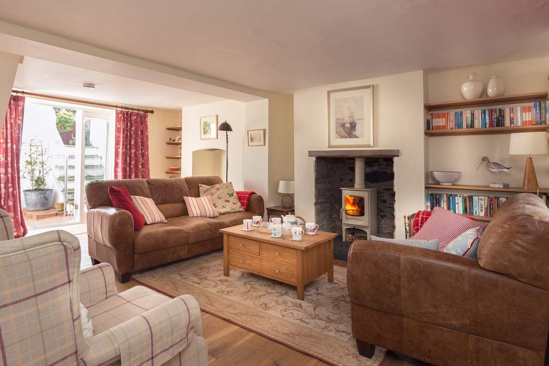 There is a wonderfully cosy sitting-room with French windows out to the patio and garden.