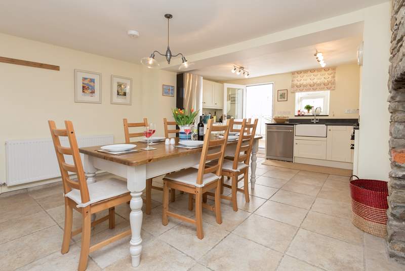 You step into this lovely kitchen with its welcoming farmhouse kitchen table, the door at the far end also opens to the courtyard patio.