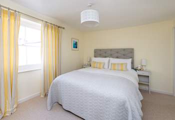 The master bedroom is beautifully designed with calm colours and a very comfortable bed. The en suite shower-room is to the right of the room.