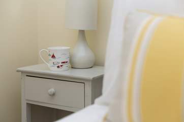 Everywhere you look there are cheerful details to welcome you to this lovely coastal cottage.