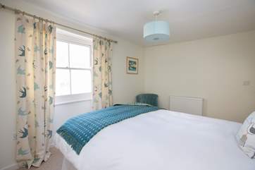 The bedroom looks out over the little pedestrian lane that takes you up to the cottage.