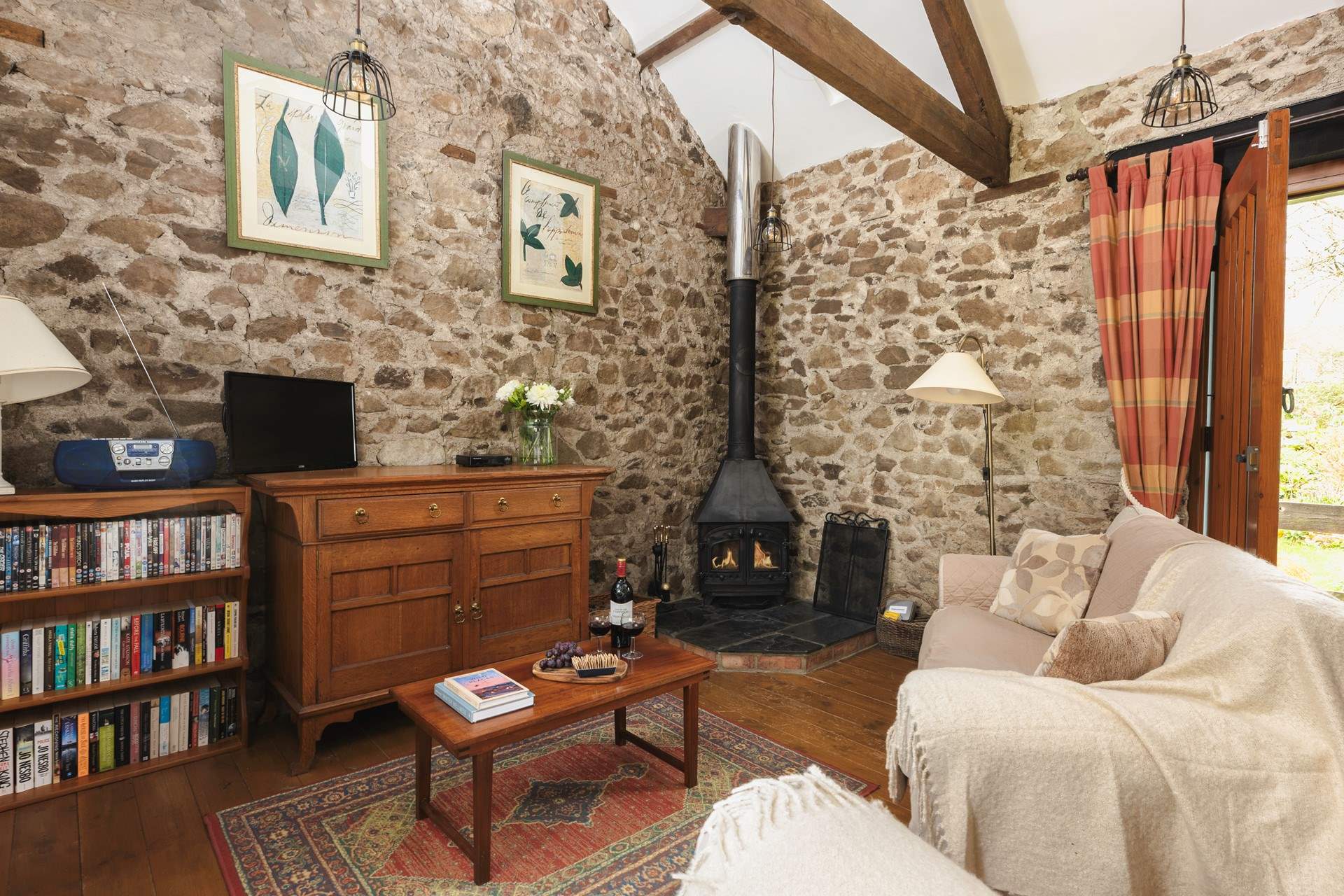 The cosy sitting room with wood-burner is the perfect place to relax no matter the season.