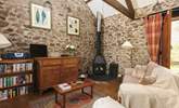 The cosy sitting room with wood-burner is the perfect place to relax no matter the season. - Thumbnail Image