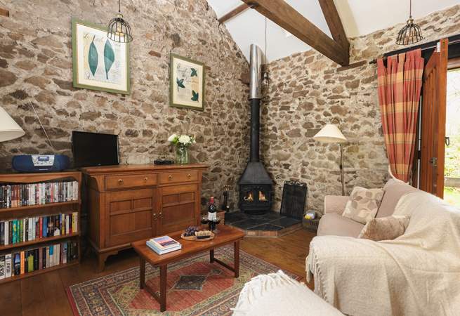 The cosy sitting room with wood-burner is the perfect place to relax no matter the season.