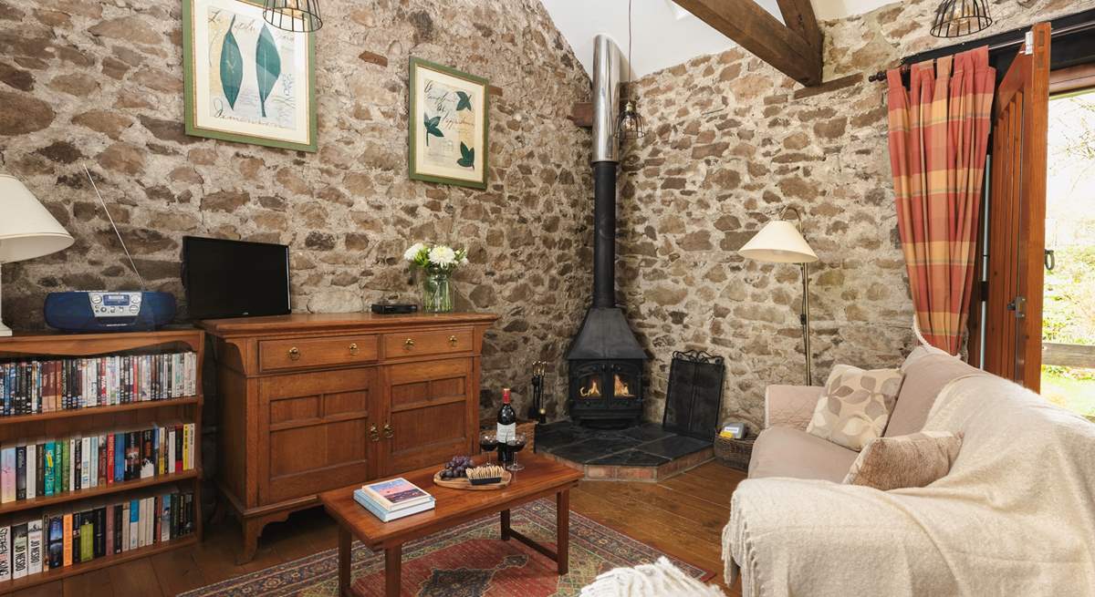 The cosy sitting room with wood-burner is the perfect place to relax no matter the season.