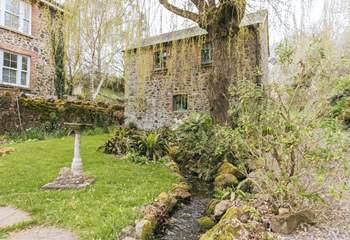 A pretty stream meanders in front of The Granary. The owners' home can be seen to the left.