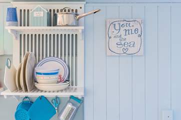 The small but perfectly formed kitchen is fully equipped with lots of useful and colourful equipment, including a 2 ring electric hob, combination microwave, toaster and fridge.