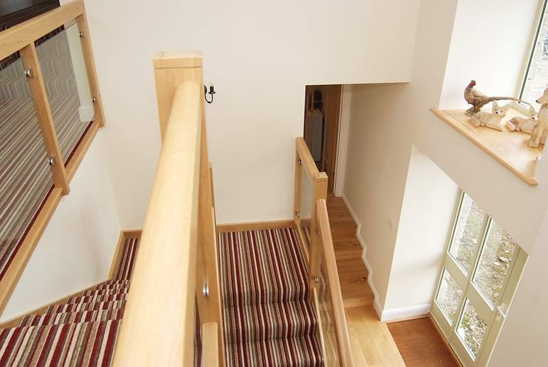 Looking down the stairs towards the steps that lead to the kitchen/dining-room.