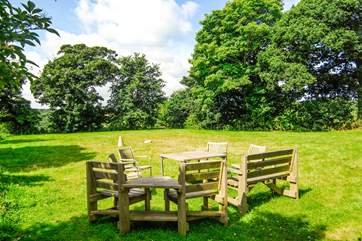 The big garden is surrounded by trees and fields.