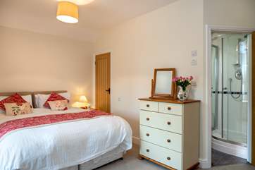 The master bedroom is spacious and has an en suite shower-room.