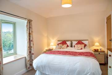 The master bedroom overlooks trees and fields (Bedroom 1).