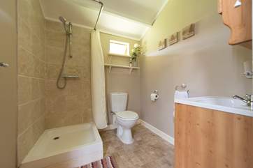 At the rear of the safari tent is a shower-room with hot shower, proper flushing toilet and wash-basin too.