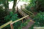 These wooden steps lead from the glamping site down to the lower meadow which has an enclosed play area, lake and network of footpaths beyond.