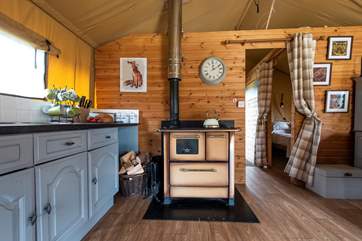 There is a log-fired range for cooking and heating, as well as a gas oven with two rings and a grill on the front deck.