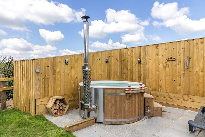 The indulgent wood-fired hot tub sits at the back of the tent.