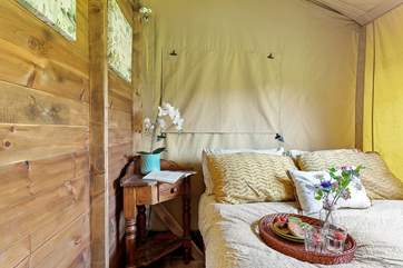 The inviting bedrooms are located at the back of the tent.