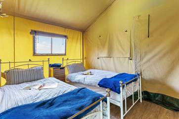Natural light floods into the delightful twin room.