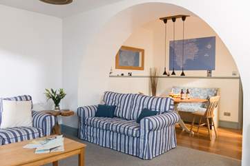The open plan sitting/dining-room is a bright, light and calm space.