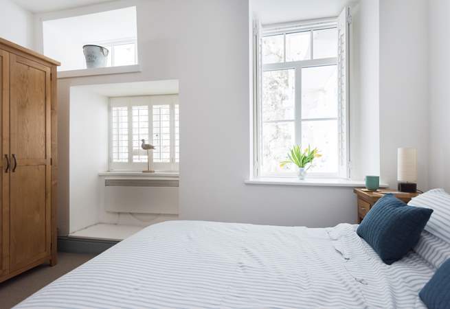 The bedrooms are to the rear of the apartment but the double-aspect windows let light flood in. 