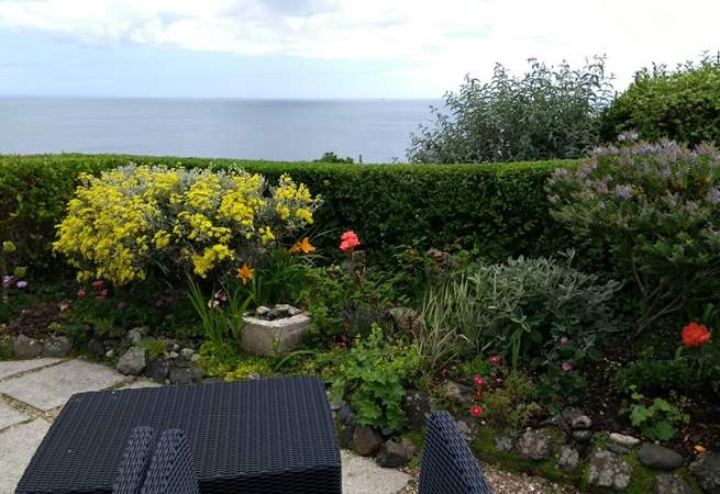 Colourful plants and flowers can be found on the patio. There are the stunning sea views. 