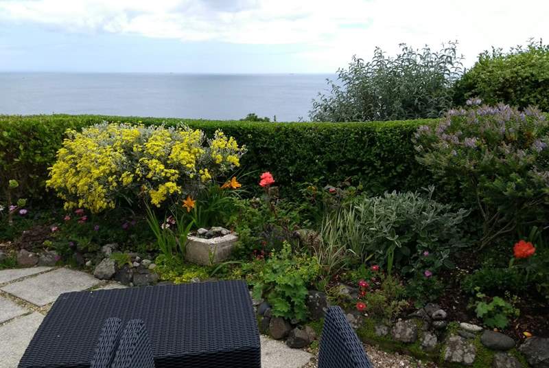 Colourful plants and flowers can be found on the patio. There are the stunning sea views. 
