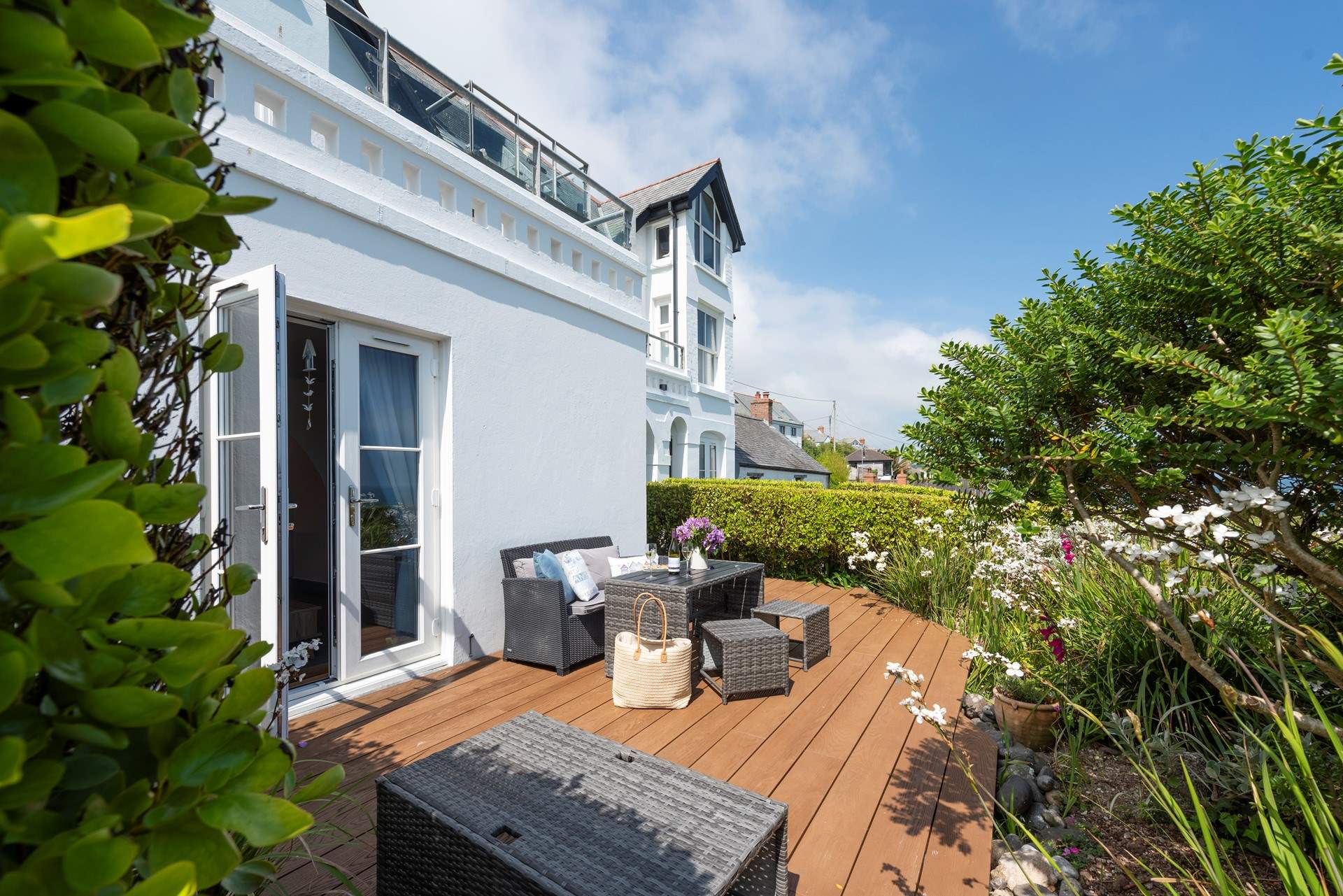 The sunny terrace is full of colour in the summer months.