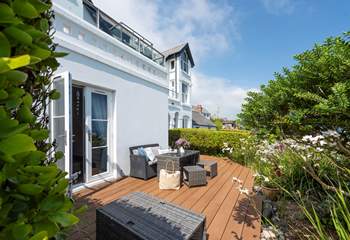 The sunny terrace is full of colour in the summer months.