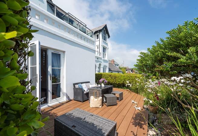 The sunny terrace is full of colour in the summer months.