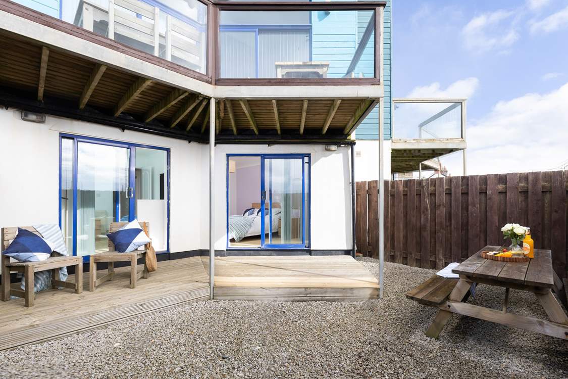 Two of the bedrooms downstairs have patio doors leading to the downstairs courtyard with outdoor furniture.