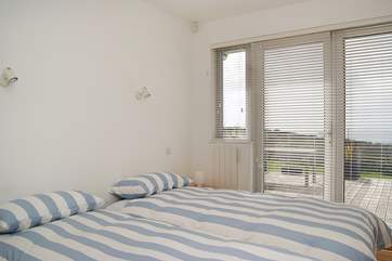 A second bedroom, bedroom 3, with access to the terrace and sea views.