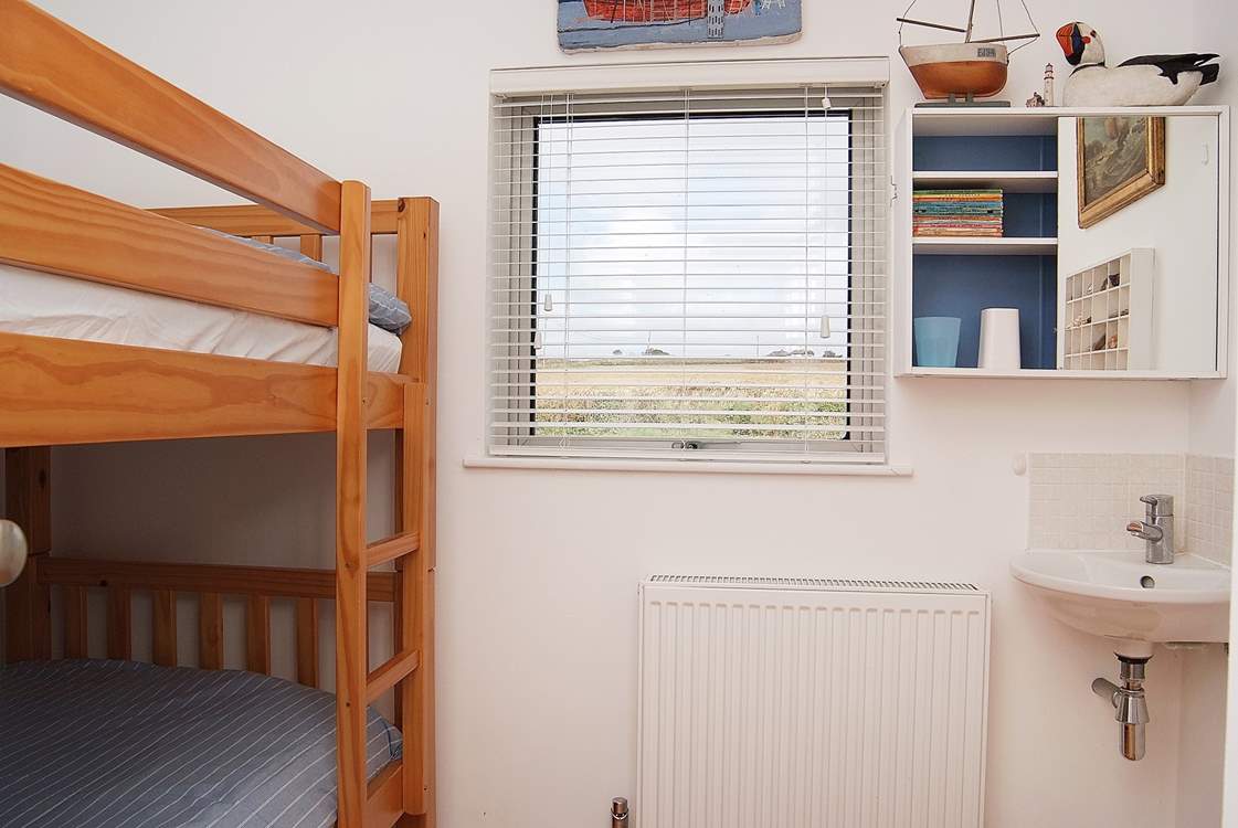 Bedroom 4 is a bunk-bed room and has a handy little sink. Perfect for little ones to brush their teeth at the end of the day.