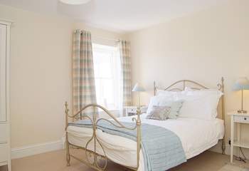 Bedroom 1 is calm and relaxing in shades of cream and duck-egg blue.