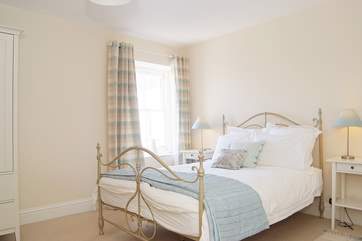 Bedroom 1 is calm and relaxing in shades of cream and duck-egg blue.