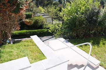 The stone steps down to the road. There is an easier route for pushchairs using a footpath in front of the house, which slopes down to the same road.