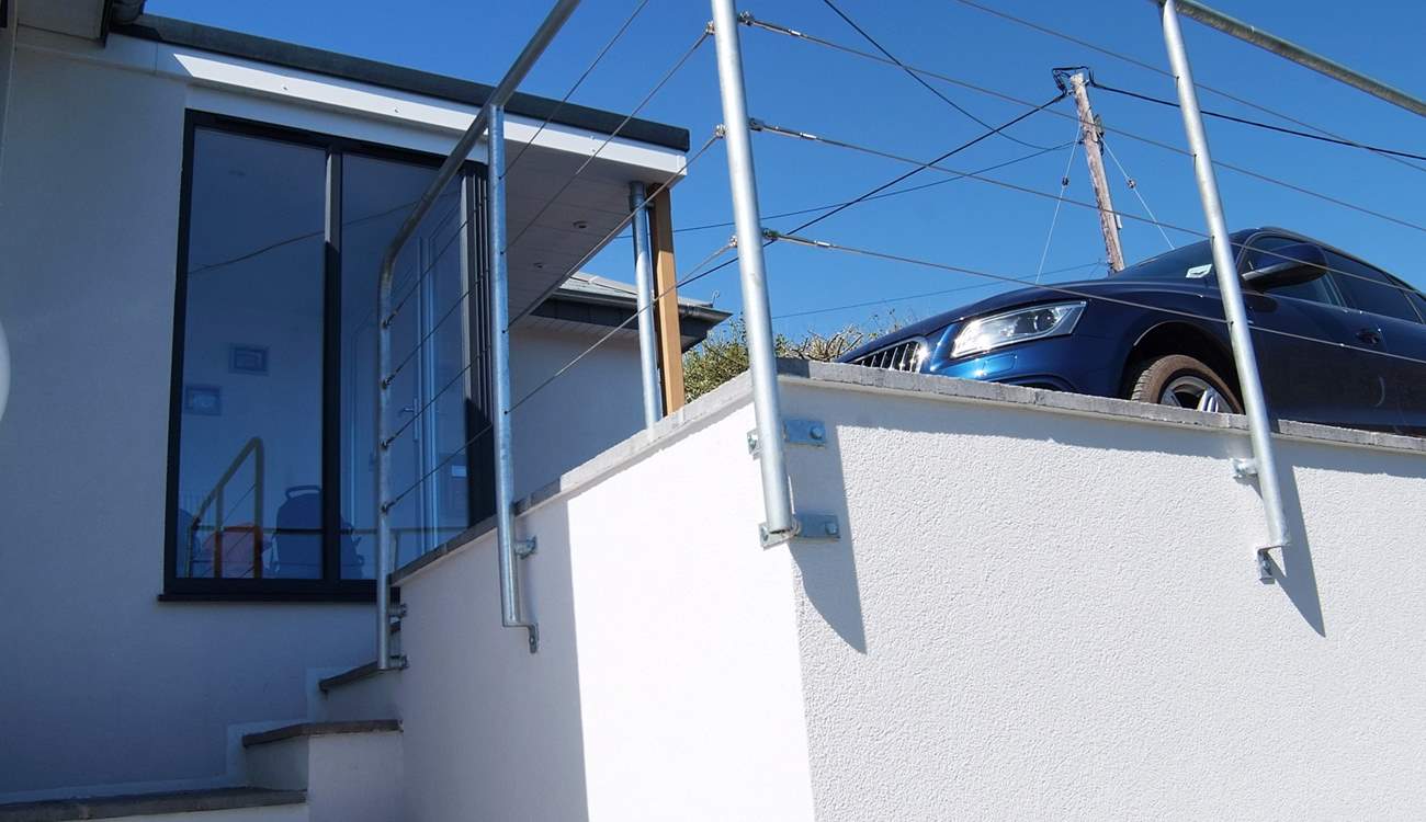 The parking-area in front of the house has space for up to three cars. Take care with small children as there is a drop on one side.