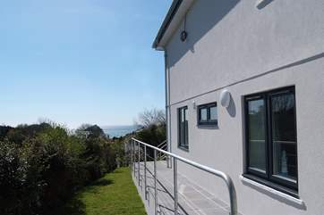 The path down beside the house and a grassed-area beside it.