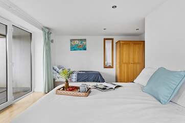 Bedroom 4 is on the lower ground and benefits from its own patio-area. This room also has a single bed option and is situated next to a large shower-room.