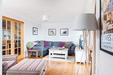 The sitting-room adjoins the dining-room through the double doors.