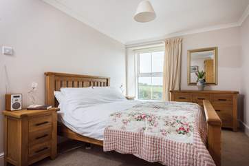 The pretty double bedroom with hand crafted wood furniture.