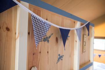 Bunting and stencils to coordinate the colour scheme.