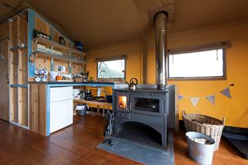 Looking towards the kitchen-area with the log-fired range (logs included) for cooking and heating.