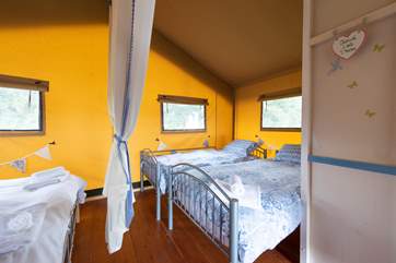 A hand-made curtain screens the bedrooms from each other and can be tied up like this during the day.
