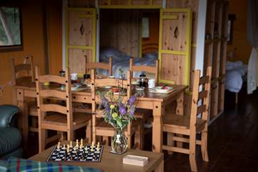Dining table with the comfortable cabin bed in the background.