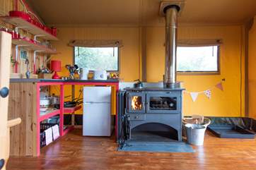 The log-fired range can be used for cooking and heating on the cooler days (logs are inclusive).
