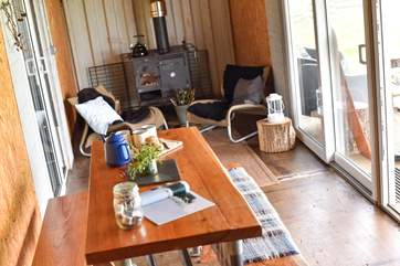 The living-room makes the most of the country views from the bespoke table and cosy sitting-area.